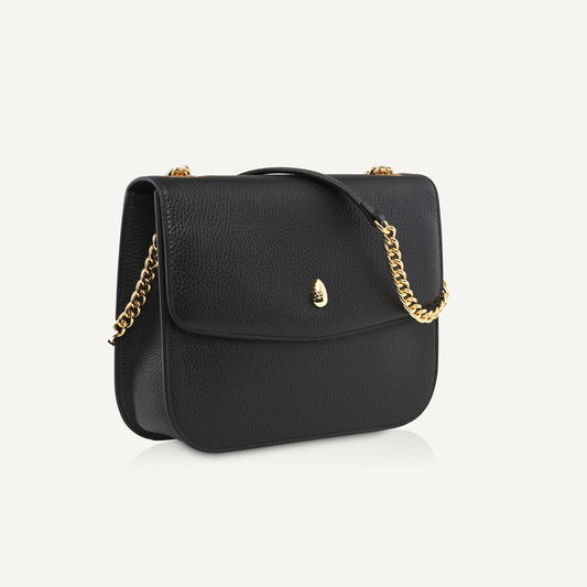 black leather shoulder bag with gold chain strap front view isolated