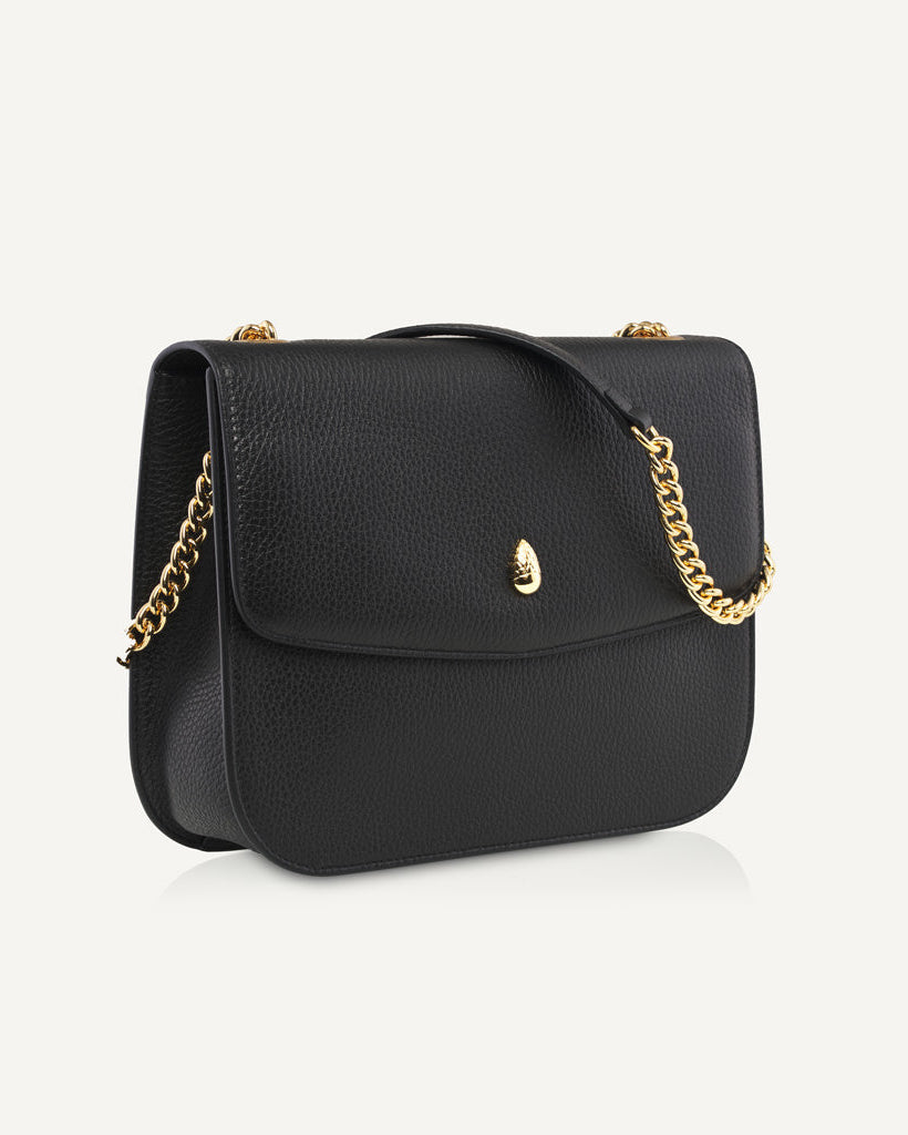 black leather shoulder bag with gold chain strap front view isolated