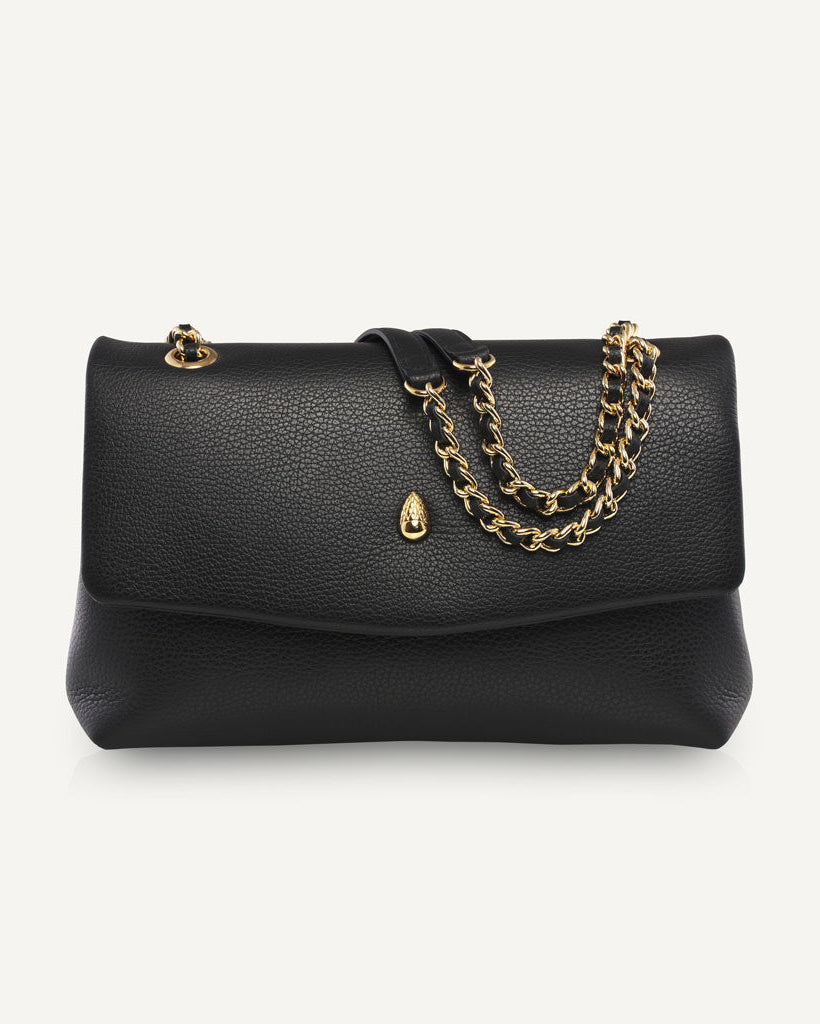 Black leather shoulder bag with gold chain on white background front view