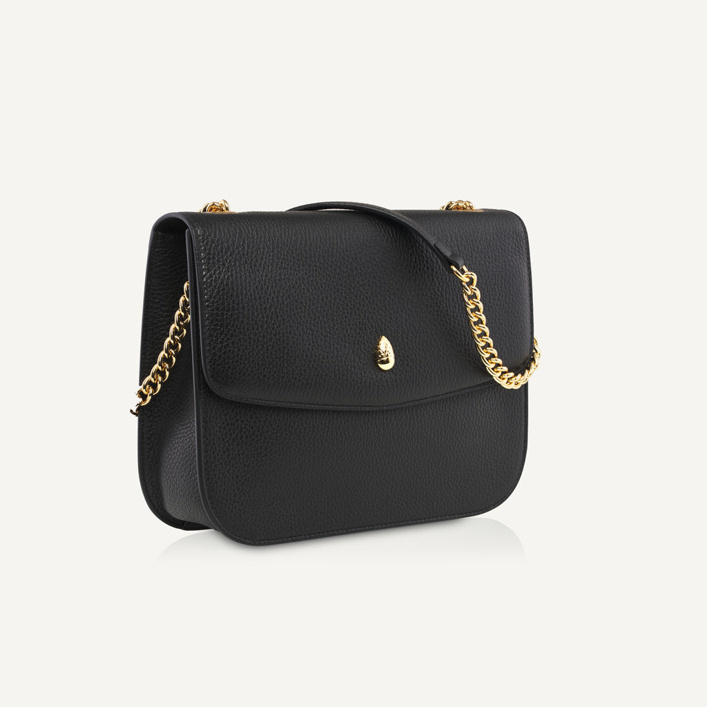 black leather shoulder bag with gold chain strap front view isolated