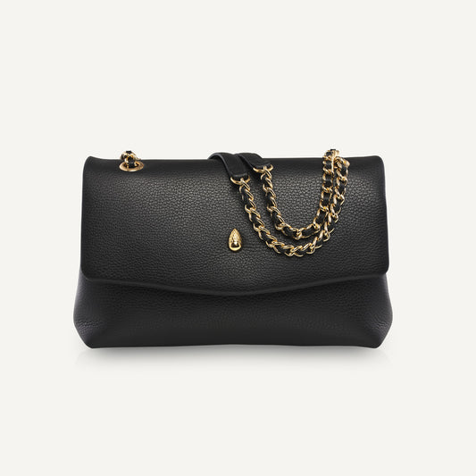 Black leather shoulder bag with gold chain on white background front view