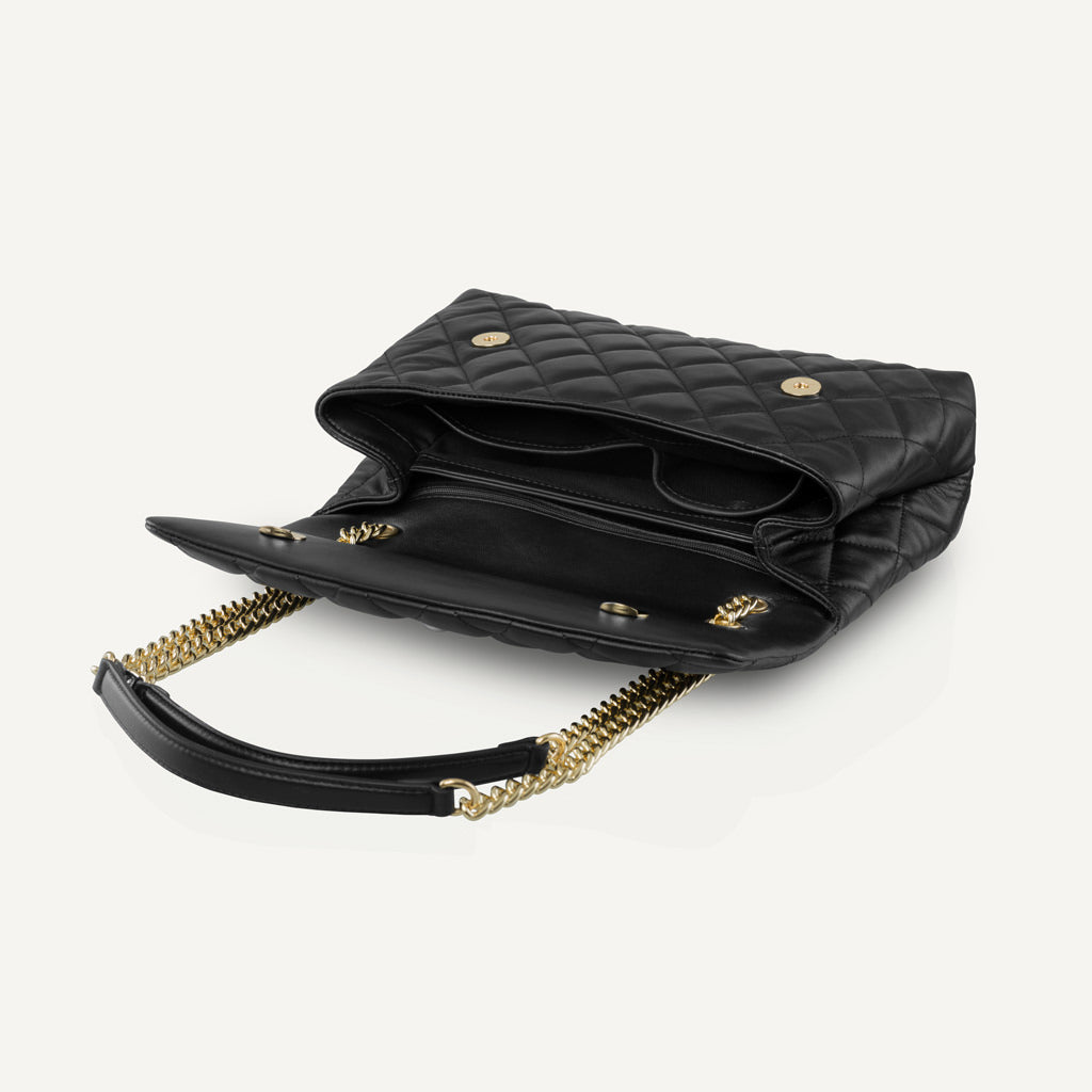Interior of a black leather bag showing compartments and lining