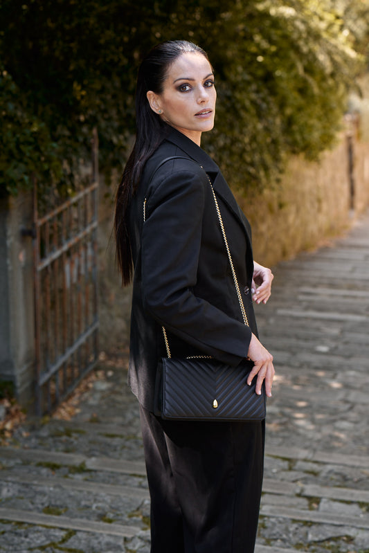 Woman wearing black leather crossbody bag elegant style – Menière Paris