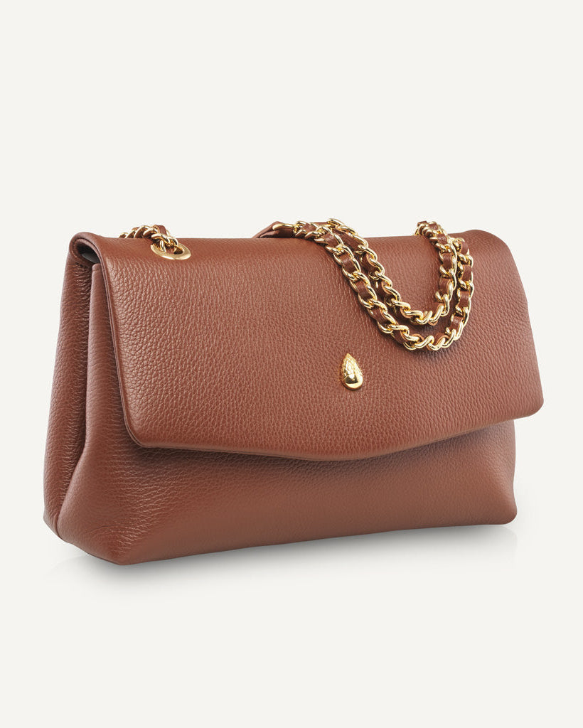 Side view of brown leather bag showing structure and shape