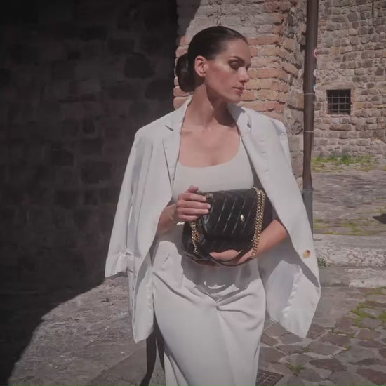 Archiduchesse quilted black leather bag in motion, showing texture and elegance by Meniere Paris