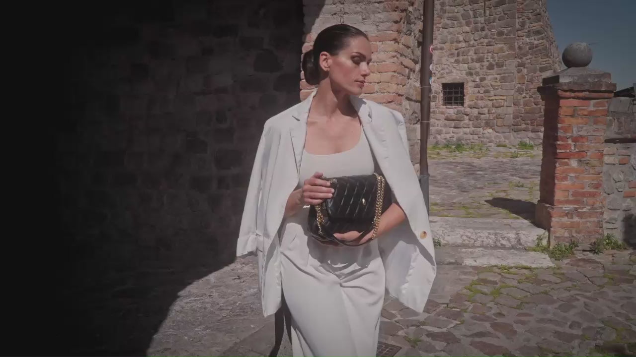Archiduchesse quilted black leather bag in motion, showing texture and elegance by Meniere Paris