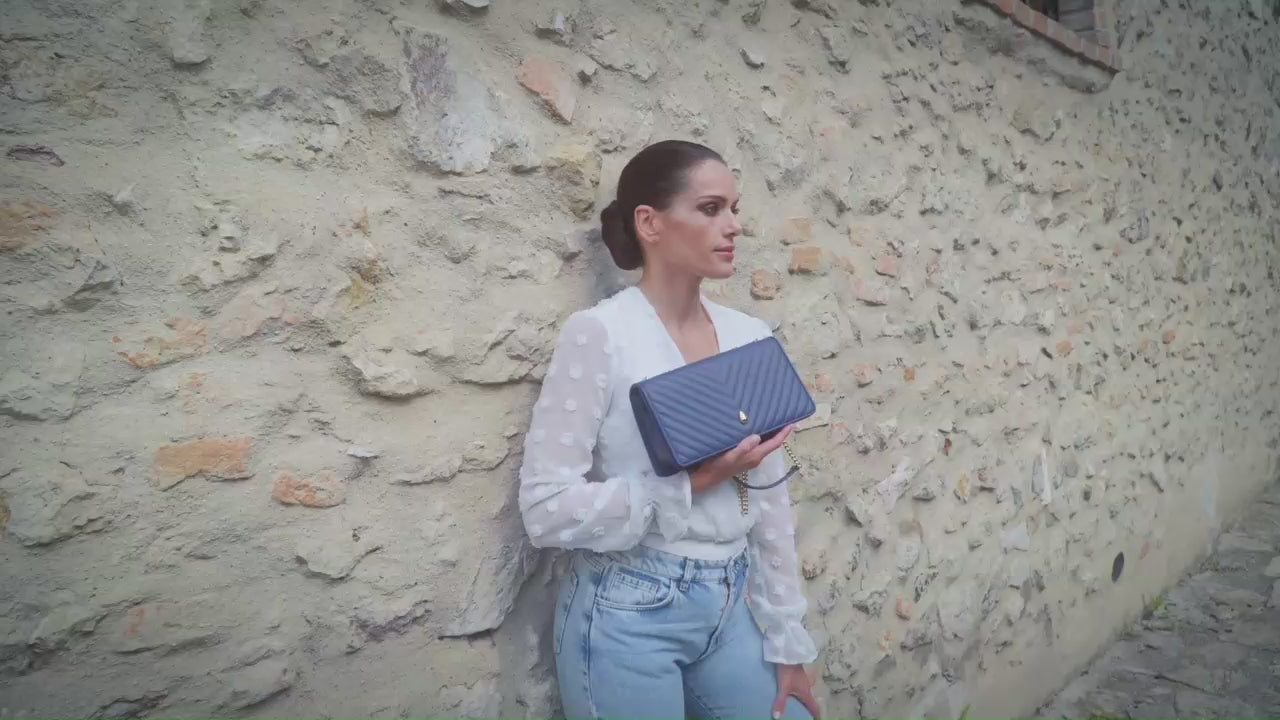 Viennois PM navy leather crossbody bag in motion showing design and functionality